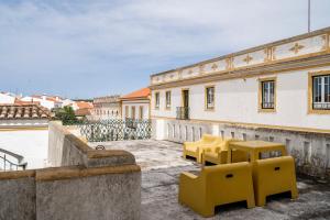 a group of yellow chairs sitting on top of a building at Casa Garcia in Amareleja