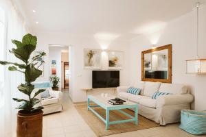 a living room with a couch and a table at Casa Morera - Best Villas Lanzarote in Teguise
