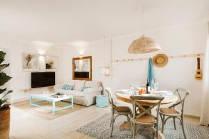 a living room with a table and a couch at Casa Morera - Best Villas Lanzarote in Teguise