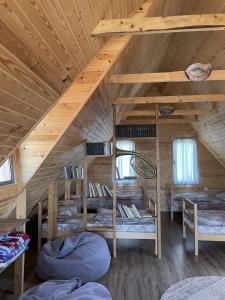 a room with four bunk beds in a wooden cabin at Armenian Camp, Sevan in Artanish