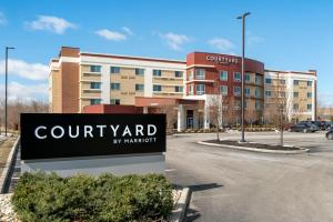 a sign in front of a building with a court yard at Courtyard by Marriott Toledo North in Toledo