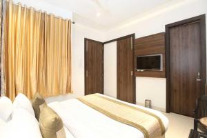 Ένα ή περισσότερα κρεβάτια σε δωμάτιο στο Hotel O Grand Star