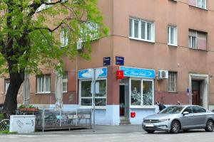 a car parked in front of a building at Apartment Elena 1, Zagreb City with garage in Zagreb