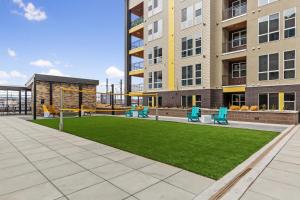 an apartment patio with a playground with blue chairs at Kasa RiNo Denver in Denver