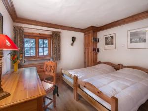 a bedroom with a bed and a desk and a table at Chalet Courchevel 1650, 7 pièces, 12 personnes - FR-1-563-17 in Courchevel