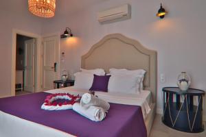 a bedroom with a large bed with towels on it at Alacaat Otel in Alaçatı +48 photos