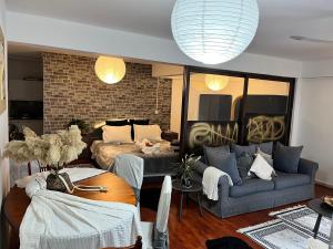 a living room with a couch and a bed at Lovely Cozy Apartment in the entrance of Nicosia in Aglantzia