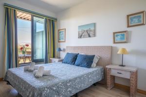 a bedroom with a bed with a view of a balcony at 1 Bed With Balcony Pool and Tennis in Quarteira