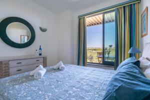 a bedroom with a bed and a view of the ocean at 1 Bed With Balcony Pool and Tennis in Quarteira