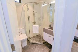 a bathroom with a shower and a toilet and a sink at Home Sweet Home in Quatre Bornes