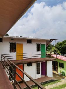 a house with colorful doors and a balcony at Hostal Puertas De Apaneca in Apaneca