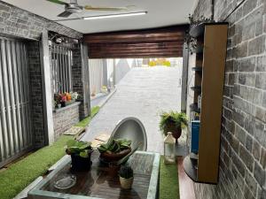 a patio with a table and plants on a brick wall at Lovely Cozy Apartment in the entrance of Nicosia in Aglantzia