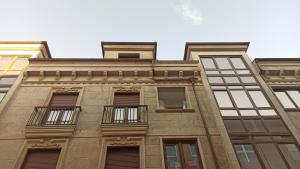 a tall brick building with windows and balconies at Aronda Cambados apartamento céntrico in Cambados