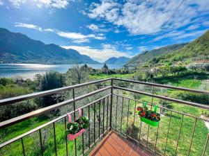 a balcony with a view of a river and mountains at Appartamento Tivano, balcone con vista lago in Bellagio