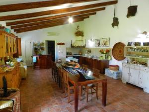 a large kitchen with a table and chairs in it at Chicchiritanos in Monti