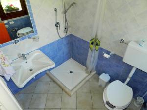 a bathroom with a shower and a sink and a toilet at Chicchiritanos in Monti +21 photos