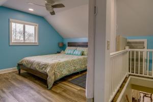 una camera con un letto con una parete blu di Dog-Friendly Manistee Home with Deck, 2 Mi to Beach! a Manistee