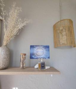 Un estante con una vela y un jarrón. en Appartement à Pramousquier Le Lavandou, en Le Lavandou