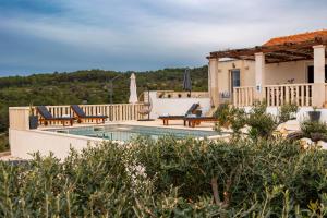 a villa with a swimming pool and a house at Villa Supetra in Supetar