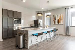 a kitchen with a large counter with stools at Contemporary 1 BDRM Apt with Pool Parking Gym in Indianapolis