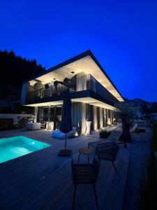 a building with a swimming pool at night at Ferienwohung Tennengau mit Parkplatz in Golling an der Salzach