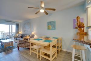 a kitchen and living room with a table and a couch at Oceanfront Carolina Beach Condo with Pool and Views! in Carolina Beach