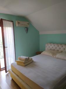 a bedroom with a large bed and a window at Vikendica Dunja in Loznica