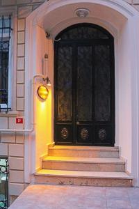 a black door with stairs in front of a building at Element Suites in Istanbul