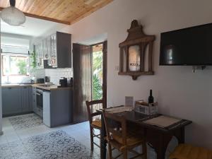 a kitchen with a table and chairs and a kitchen with a counter at Liakoto in Panayia