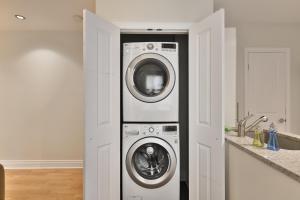 a kitchen with a washer and dryer in a room at STUNNING full APARTMENTS - stocked KITCHENS - WASHER & DRYERS - WORKSPACE PROVIDED - FAST WIFI - LOCATED on the FAMOUS ST Denis street - Near METRO MONT ROYAL in Montreal +46 photos
