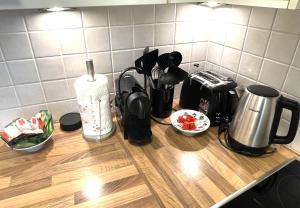 a counter top with a coffee maker and appliances on it at Kurhaus Apartment + parking in Merano