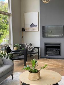 a living room with a couch and a fireplace at Ralphie’s Villa 2 bed 2 bath with Valley views in Kangaroo Valley
