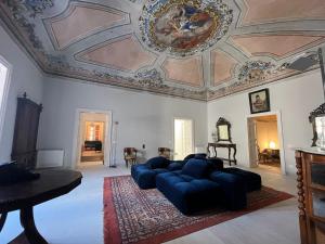 a living room with a couch and a ceiling at Palazzo Triolo - Dimora di Charme in Corleone
