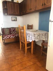 a dining room with a table and a couch at Barbara’s Traditional House & Apartment in Menetaí