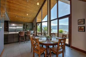 a kitchen and dining room with a table and chairs at Lake House at Quails' Gate Winery in West Kelowna