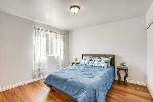 a white bedroom with a bed and a window at Sunny Oakland Vacation Rental - 6 Mi to Downtown in Oakland