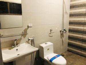 a bathroom with a toilet and a sink at Star House in Islamabad
