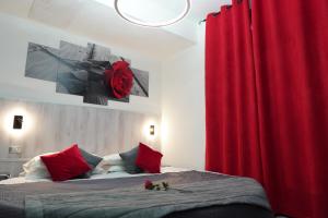 a bedroom with a bed with a red curtain at Hotel Canarino in Riva del Garda