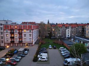 a parking lot with cars parked in a city at Justinrent 1 in Legnica