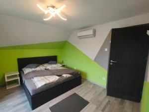 a bedroom with a bed and a ceiling fan at Kikapcs apartman in Alsóörs