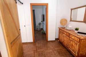 a room with a wooden dresser and a mirror at La Barbería de Miguel in El Chorro