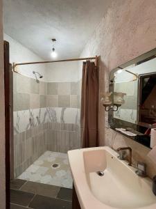 a bathroom with a tub and a sink and a shower at Hotel SPA Campestre Los Adobes in Taxco de Alarcón