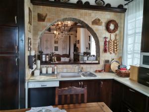 a kitchen with a sink and an archway over a counter at Maronia Luxury Villa in Maronia