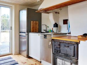 a kitchen with a stainless steel refrigerator and a sink at 5 person holiday home in YXLAN in Yxlö