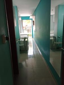 a hallway of a hospital with a table and chairs at Manawa Beach Flats Prime in Porto De Galinhas