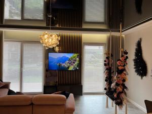 a living room with a couch and a flat screen tv at Golden Life in Kielce