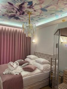 a bedroom with a bed with a flower ceiling at Golden Life in Kielce