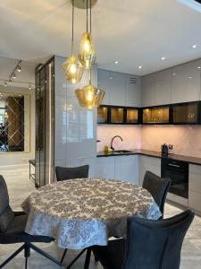a kitchen with a table and chairs in a room at Golden Life in Kielce