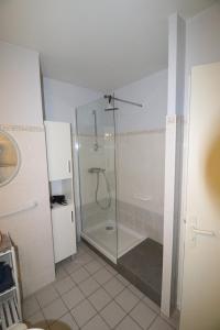 a shower with a glass door in a bathroom at Idéal , Plein centre-ville tout confort in Espalion
