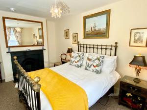 a bedroom with a bed and a fireplace at Lala Mundi in Brading